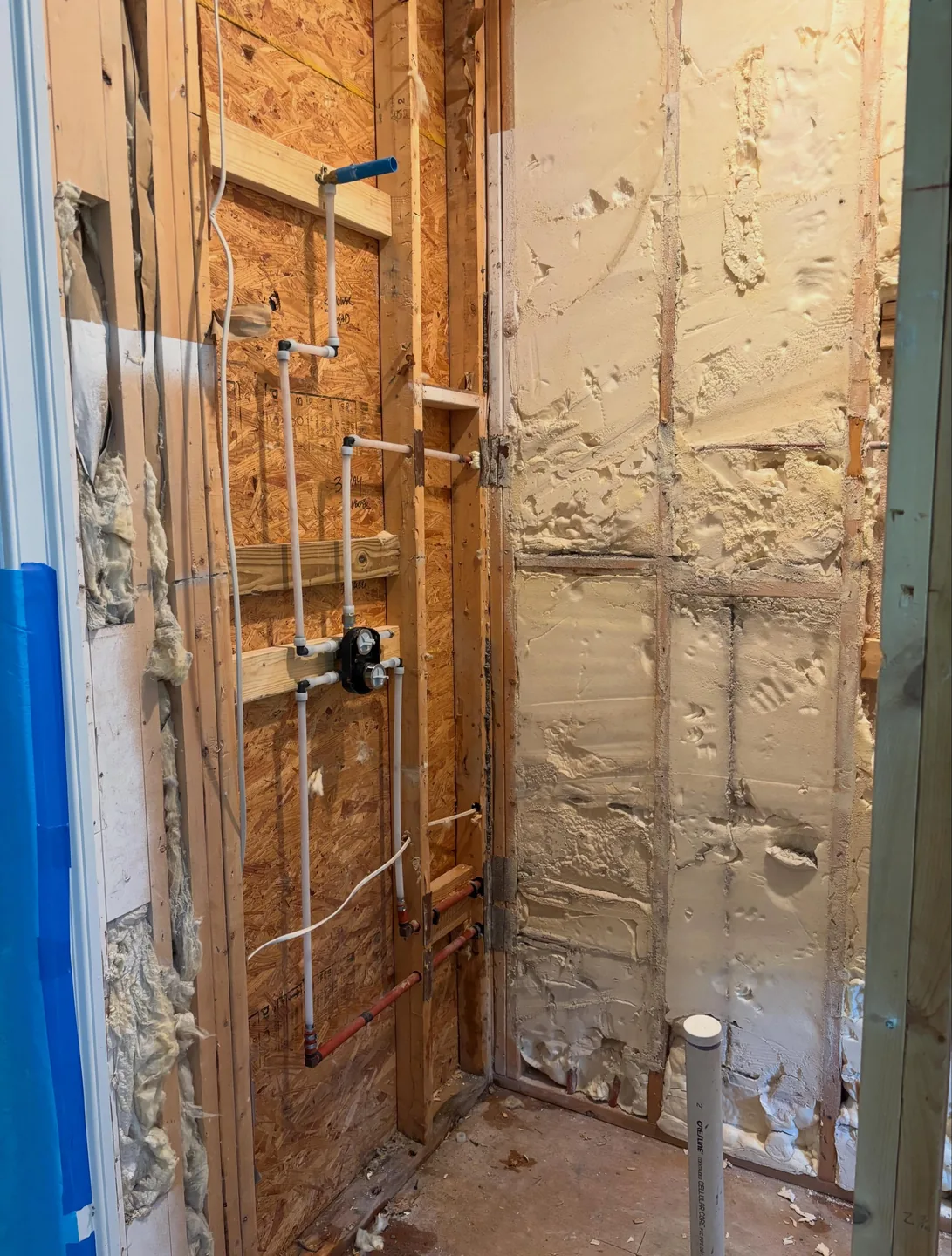 Exposed water and drain piping during a Charleston-area bathroom renovation